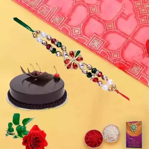 Splendid Combo Gift of Yummy Chocolaty Cake and a Single Rose with Free Rakhi Roli Tilak and Chawal